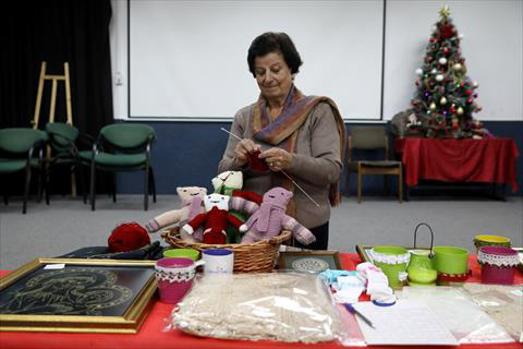 Efaf Srouji knits during a Christmas workshop to teach embroidery in the city of Nazareth on December 6 (Reuters photo)