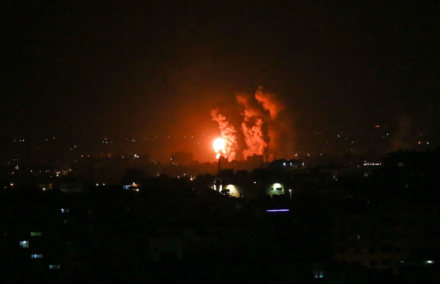 Flames and smoke rise during Israeli air strikes on central Gaza strip on Thursday (AFP photo)