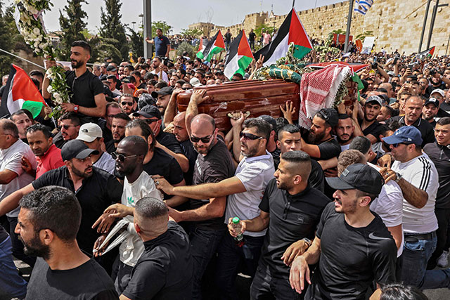 Palestinian mourners carry the casket of slain Al-Jazeera journalist Shireen Abu Aklel from a church towards the cemetary, during her funeral procession in Jerusalem, on Friday (AFP photo)