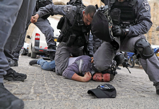   Israeli forces detain a Palestinian protester during scuffles outside the compound housing Al Aqsa Mosque in Jerusalem’s Old City, on Tuesday (Reuters photo)