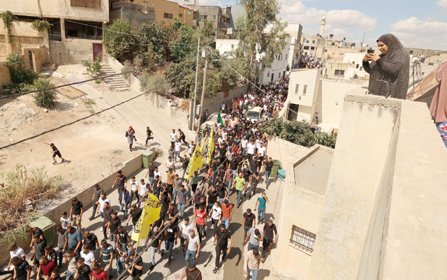 Palestinians march in the village of Kafr Dan, to show solidarity with the families of two Palestinians killed in overnight clashes with Israeli forces near a checkpoint north of the occupied West Bank town of Jenin, on Wednesday (AFP photo)