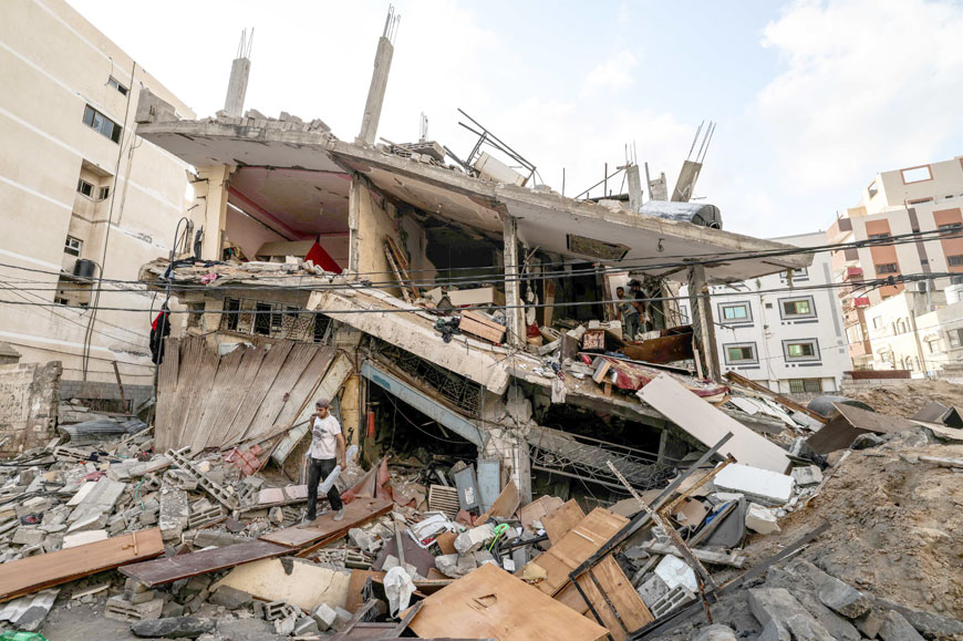 Palestinians salvage belongings from the rubble of their home, following Israeli air strikes in Gaza City, on Sunday (AFP photo)