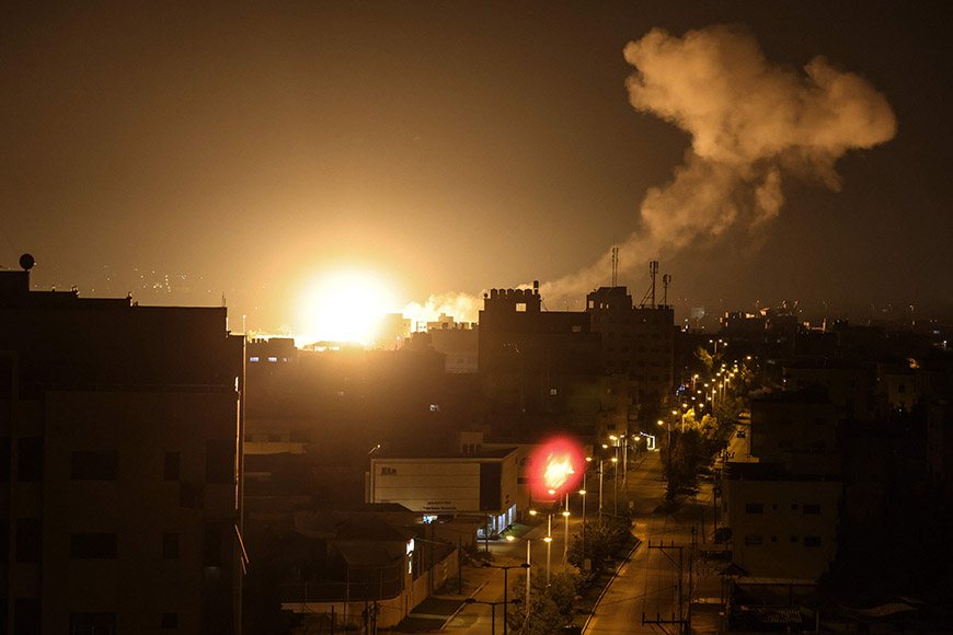 Fire and smoke rise above buildings in Gaza City as Israel launched air strikes on the Palestinian enclave early on Friday (AFP photo)