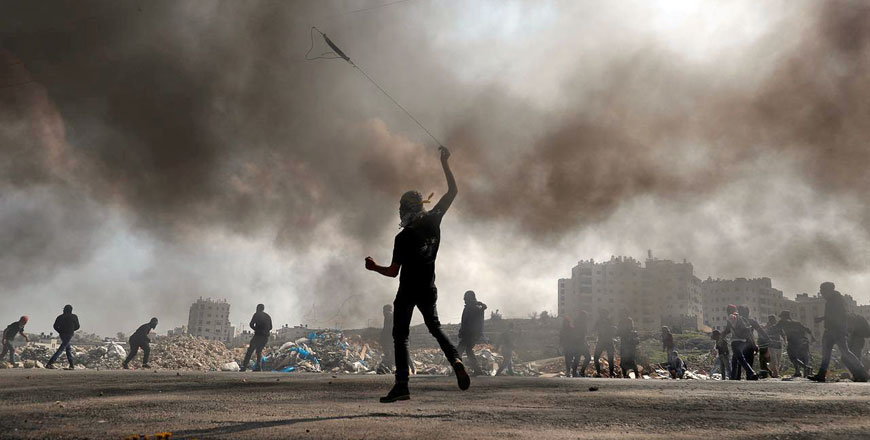 Palestinian protesters hurl stones at Israeli forces during confrontations near the Jewish settlement of Beit El, in the Israeli-occupied West Bank, on Wednesday (Reuters photo)