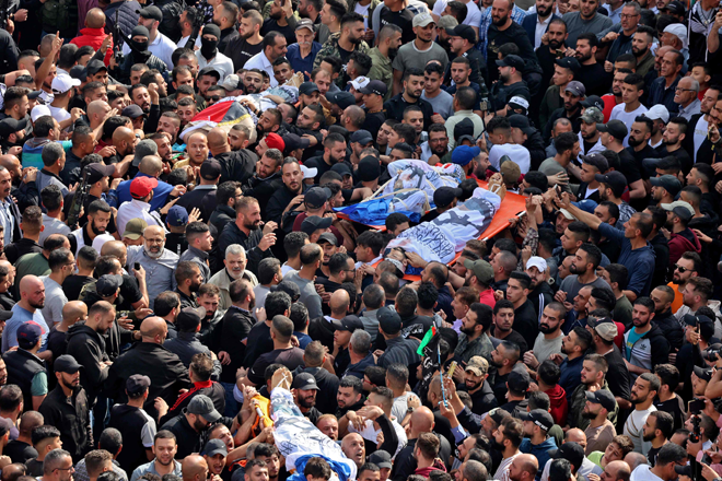 Mourners attend the funeral of Palestinians killed in an overnight Israeli raid, in the occupied West Bank city of Nablus, on Tuesday (AFP photo)
