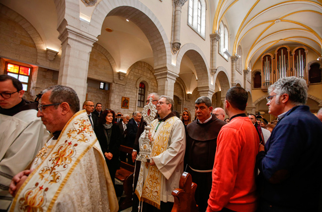 The Custos of the Holy Land Francesco Patton (centre), carries the Relic of the Holy Crib of the Child Jesus, during a procession at the Church of the Nativity compound in Bethlehem on Saturday, initiating celebrations for the arrival of the relic, a gift from the Pope Francis to the Custody of the Holy Land (AFP photo)