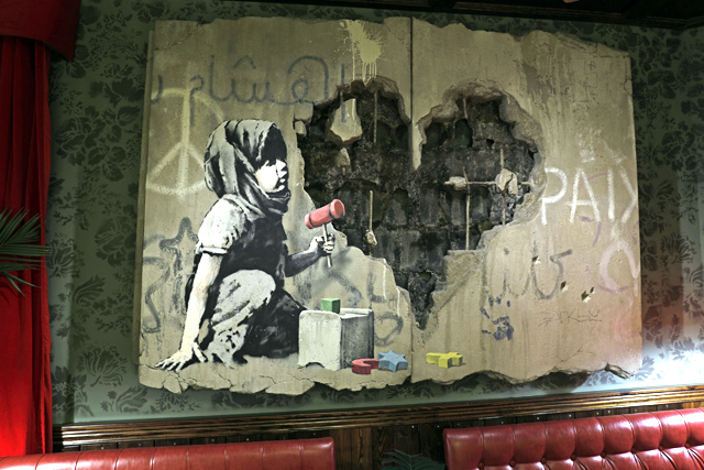 An illustration by street artist Banksy is displayed in his Walled-Off hotel in the Israeli occupied West Bank town of Bethlehem on Friday (AFP photo)