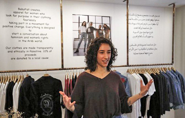 Palestinian designer Yasmeen Mjalli started painting slogans on her own clothes when the family relocated to the West Bank on Tuesday (AFP photo)