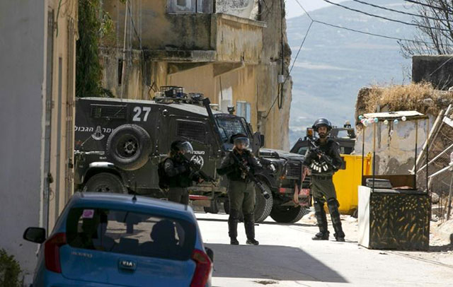 Israeli soldiers in the village of Yabad near the West Bank city of Jenin on Tuesday after the death of an Israeli soldier killed by a rock hurled by a Palestinian (AFP photo)