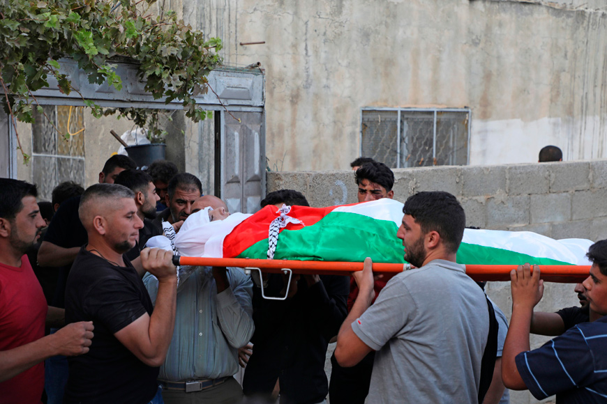 Palestinian mourners carry the body of 18-year-old Amer Abdel Rahim Sanouber, who died following a confrontation with Israeli forces, during his funeral in the village of Yatma in the occupied West Bank, on Sunday (AFP photo)