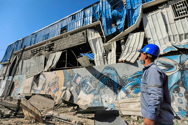 A Palestinian man checks damage caused by an Israeli air strike on Gaza City, on Saturday (AFP photo)