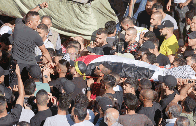 Palestinians carry the body of Tareq Erdis, who died during an Israeli operation in the Askar refugee camp, east of Nablus, in the occupied West Bank during his funeral on Saturday (AFP photo)