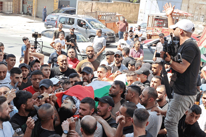 Mourners carry the body of Palestinian Mohammed Abd Al Hakim Nada who was killed in an Israeli raid in the occupied West Bank, during his funeral at Al Ain camp in Nablus, on Wednesday (AFP photo)