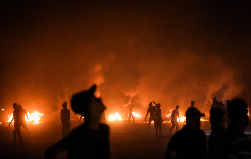 Palestinian protesters burn tyres following a demonstration along the border between the Gaza Strip and Israel east of Gaza City on Saturday (AFP photo)