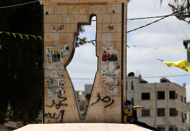 A Palestinian boy walks past a moument showing a map of Mandatory Palestine in the West Bank town of Jenin in the north of the occupied West Bank on Tuesday (AFP photo)