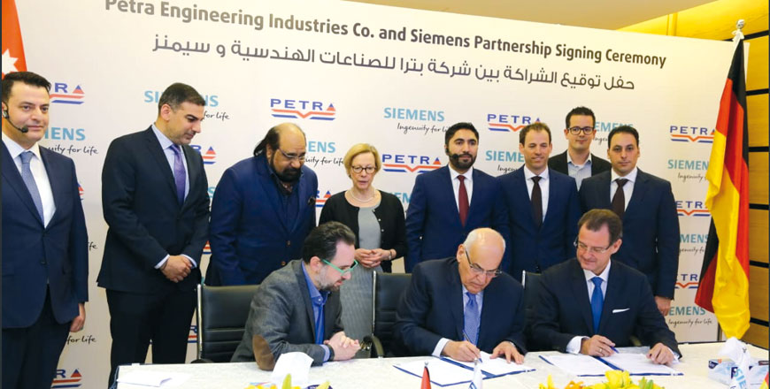 Semiens executive Markus-Erich Strohmeier (first right), Petra Engineering Industries Co. Vice Chairman Omar Abu Wishah (first centre) and Operations Director Omar Ali (first left) sign partnership agreement at Petra’s facilities, southeast of Amman, on Sunday, with German Ambassador to Jordan Birgitta Siefker–Eberle (centre back) overseeing the signing of the deal (Photo courtesy of Petra Engineering Industries Co)