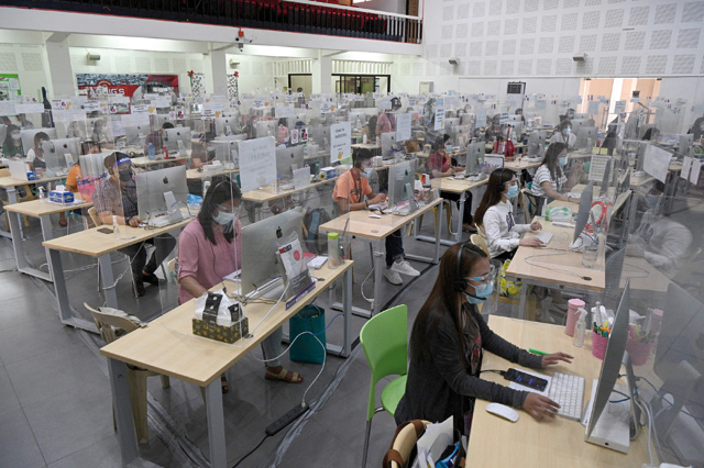 In this photo taken on March 3, registered teachers wearing face masks and shields conduct teleconferencing sessions to help struggling students as part of a local government-sanctioned online tutorial initiative in Taguig City, suburban Manila  (AFP photo)