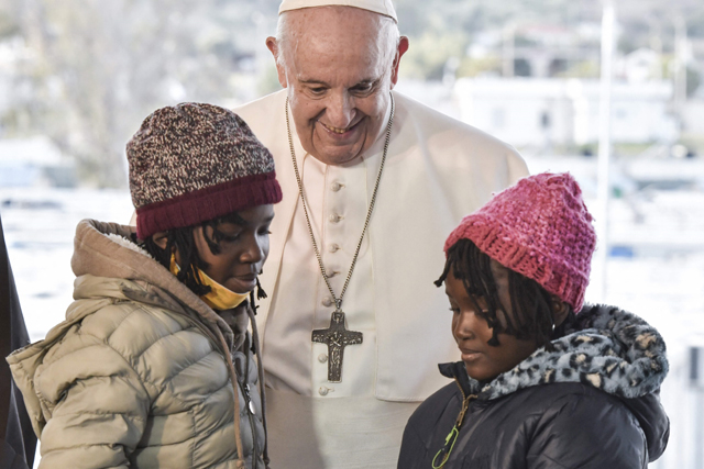 Pope Francis greets two young refugee girls at the Reception and Identification Centre in Mytilene on the island of Lesbos on Sunday (AFP photo)