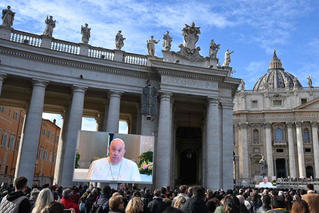 Faithfuls gather to attend the Angelus prayer on a screen, led by Pope Francis in St Peter’s Square at the Vatican on Sunday (AFP photo)