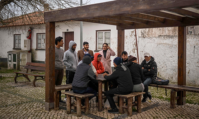 Asian immigrants gather at the end of the day at a square in Sao Teotonio, Odemira (AFP photo)