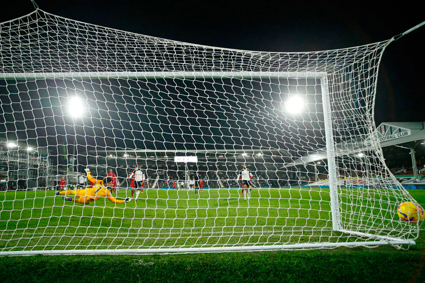 Liverpool’s Brazilian goalkeeper Alisson Becker (left) dives but cannot stop a shot from Fulham’s Jamaican striker Bobby Decordova-Reid opening the scoring during the English Premier League football match between Fulham and Liverpool at Craven Cottage in London on Sunday  (AFP photo)