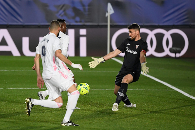 Real Madrid’s French forward Karim Benzema (left) and Real Madrid’s Brazilian forward Vinicius Junior (centre) challenge Athletic Bilbao’s Spanish goalkeeper Unai Simon during the Spanish league football match between Real Madrid CF and Athletic Club Bilbao at the Alfredo di Stefano Stadium in Madrid on Tuesday  (AFP photo)