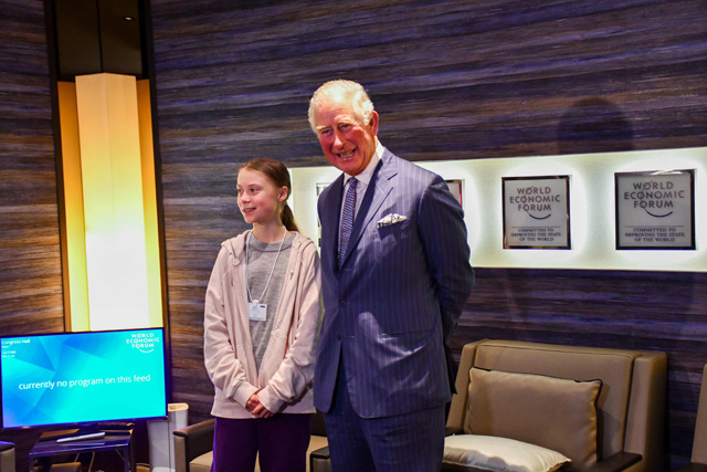 This handout photo released by Clarence House on Wednesday shows Prince Charles, prince of Wales (right), greeting Swedish climate activist Greta Thunberg  at the World Economic Forum annual meeting in Davos  (AFP photo)