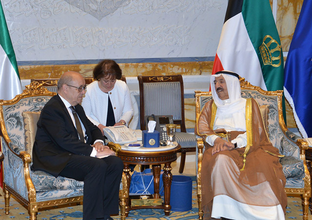 A photo provided by the Kuwaiti news agency KUNA on Sunday shows the Emir of Kuwait Sheikh Sabah Al Ahmad Al Sabah (right) meeting with French Foreign Minister Jean-Yves Le Drian at Bayan Palace in Kuwait City on Sunday (AFP photo)