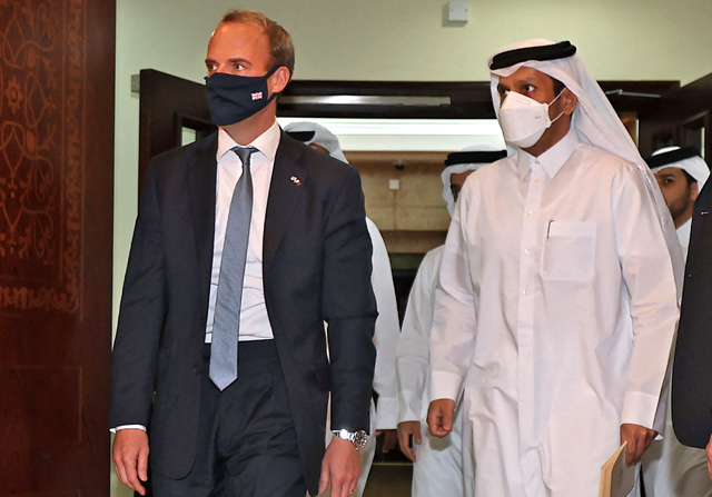 Britain's Foreign Secretary Dominic Raab (left) and his Qatari counterpart Sheikh Mohammed bin Abdulrahman Al Thani, arrive to give a joint press conference in the capital Doha, on Thursday (AFP photo)