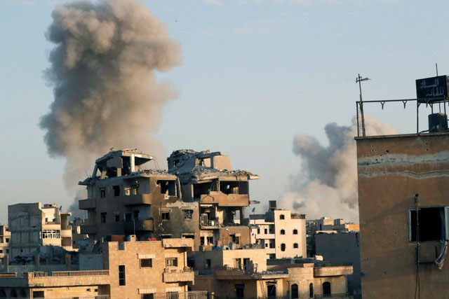 Smoke billows at different positions of Daesh militants at the stadium after an air strike by coalition forces, at the frontline in Raqqa, Syria, on Saturday (Reuters photo)