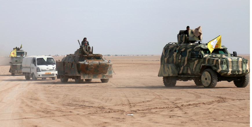 Syrian Democratic Forces fighters ride on vehicles in the north of Raqqa city, Syria, February 5 (Reuters file photo)
