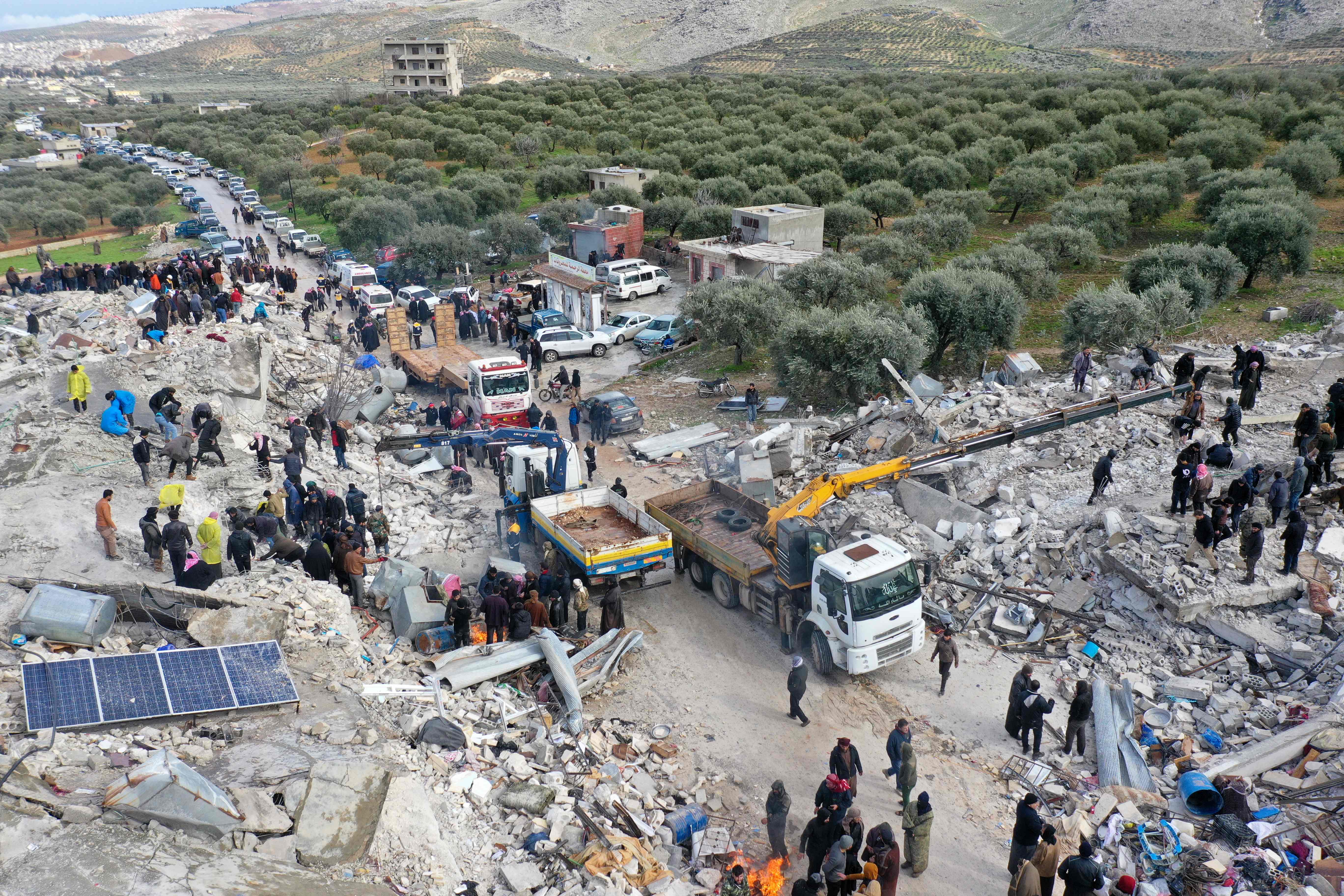 This aerial view shows residents searching for victims and survivors amidst the rubble of collapsed buildings following an earthquake in the village of Besnia near the town of Harim, in Syria's rebel-held northwestern Idlib province on the border with Turkey, on Monday (AFP photo Omar Haj Kadour)