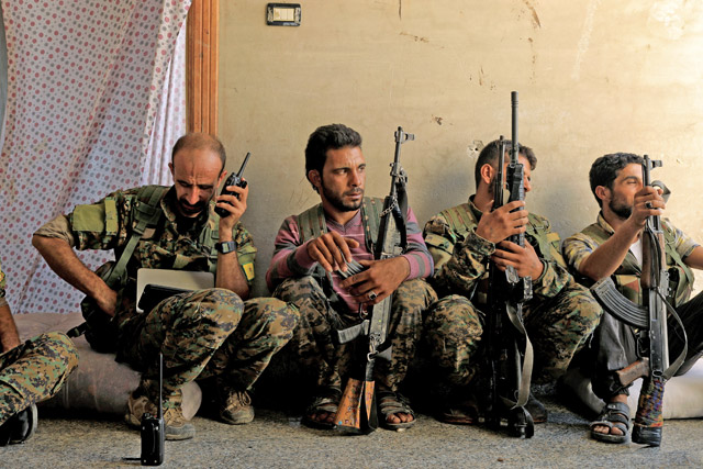 Members of the Syrian Democratic Forces keep guard at their advanced position, during the fighting with Daesh militants in Nazlat Shahada, a district of Raqqa, Syria, on Wednesday (Reuters photo)