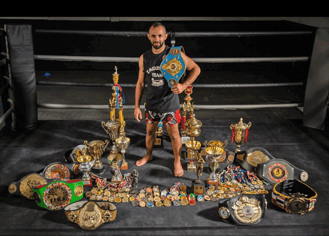 Saif Aldeen Zaqzouq poses for a photo with his trophies and medals (Photo courtesy of Saif Aldeen Zaqzouq)