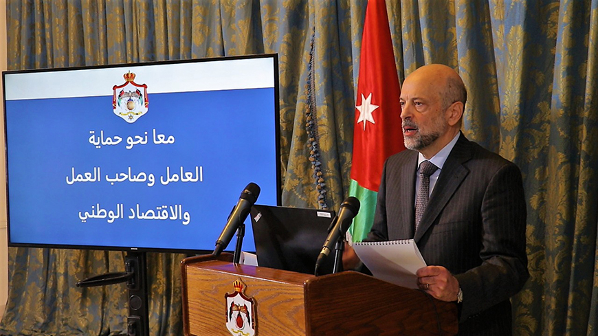 Prime Minister and Minister of Defence Omar Razzaz announces Defence Order No. 6, which outlines the rights of workers under the Defence Law, in a televised statement on Wednesday (Petra photo)