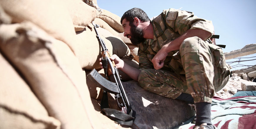 A fighter from the Nureddine Al Zinki unit, a moderate Syrian opposition faction affiliated with the Muslim Brotherhood and made up of former Syrian Free Army fighters, mans a position in a rebel-held part of Aleppo province that lies directly east of the main opposition bastion in Idlib, on Sunday (AFP photo)