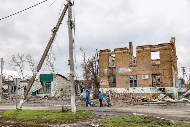Local residents walk down a street in the village of Drobysheve in eastern Ukraine's Donetsk region, on Friday (AFP photo)