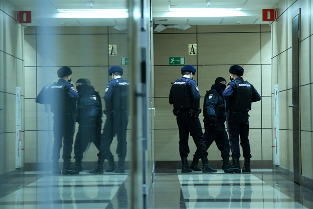 Police officers are seen in a hallway of a business centre, which houses the office of opposition leader Alexei Navalny’s Anti-Corruption Foundation, in Moscow, on Wednesday (AFP photo )