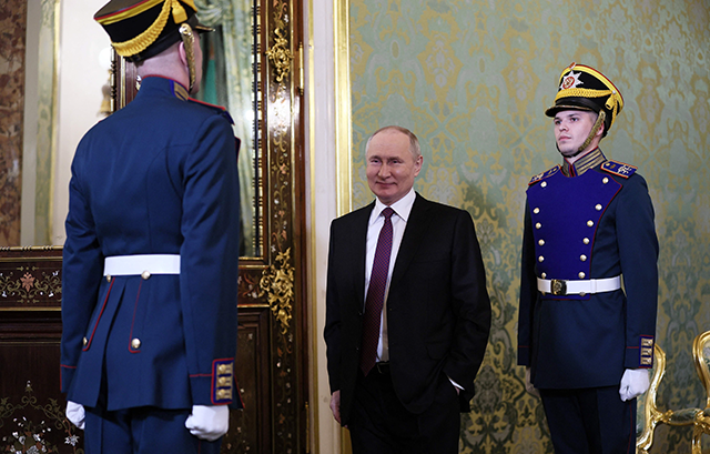 In this photograph distributed by Russian news agency Sputnik on Thursday, Russia's President Vladimir Putin waits to meet with Iran's president in the Kremlin, in Moscow  (AFP photo)