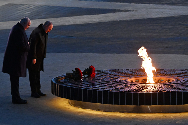 In this pool photo distributed by Russian state agency Sputnik, Russia’s President Vladimir Putin (right) and Belarus’ President Alexander Lukashenko  lay flowers during the opening ceremony of a monument to civilians killed during World War II near the village of Zaitsevo, Leningrad region, on Saturday (AFP photo)