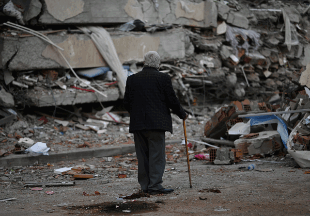 A man walks among debris of collapsed buildings in Kahramanmaras, on March 4, one month after a massive earthquake struck southeast Turkey (AFP photo)