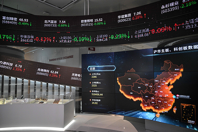 This photo shows a general view of screens diplaying financial market movements at the new building of the Shanghai Stock Exchange in Shanghai on Friday (AFP photo)