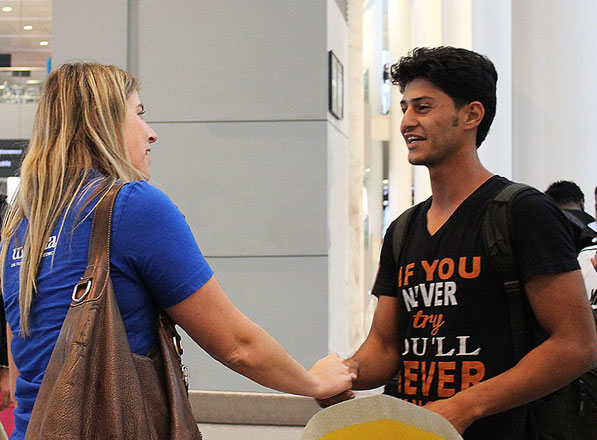 A WUSC staff member welcomes a young student to Canada through the Student Refugee Programme (Photo courtesy of WUSC)