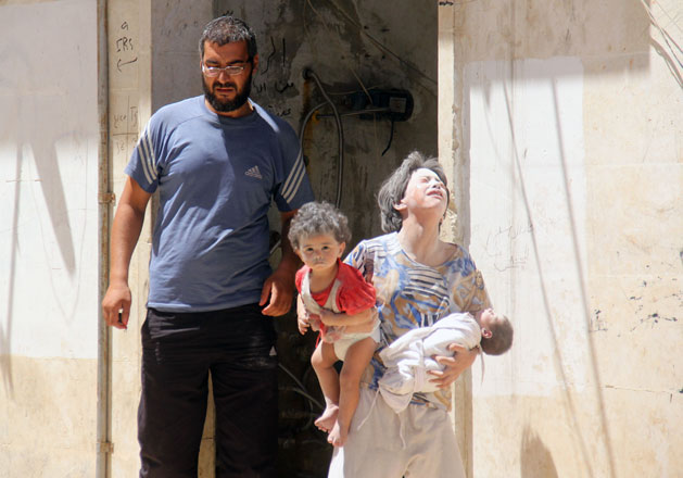 Syrian civilians are seen following a reported air strike by Syrian government forces on the rebel-held northwestern city of Idlib, on Wednesday,  More than 280,000 people have been killed and millions displaced since Syria’s civil war erupted with the brutal repression of anti-government protests in 2011  (AFP photo)