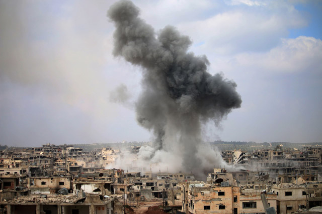 Smoke billows following a reported air strike on a rebel-held area in the southern Syrian city of Daraa, on Sunday (AFP photo)