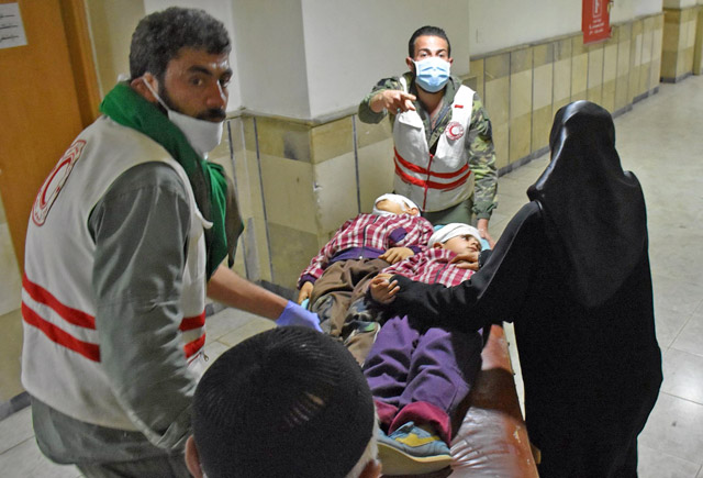 Syrian boys who were injured in a car-bomb blast on April 15 while civilians were waiting at a transit point during their evacuation from the sieged government-held towns of Kafraya and Fuaa in a deal made between the government and the rebels, are wheeled on a gurney as they arrive at a hospital in the northern city of Aleppo to receive medical treatment on Wednesday (AFP photo)