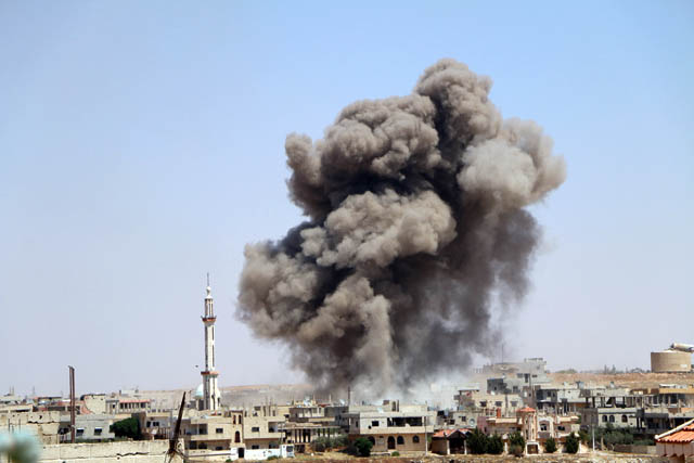 Smoke rises after a reported government barrel bomb air strike over residential areas in Daraa, Syria,  on Thursday (Anadolu Agency photo)