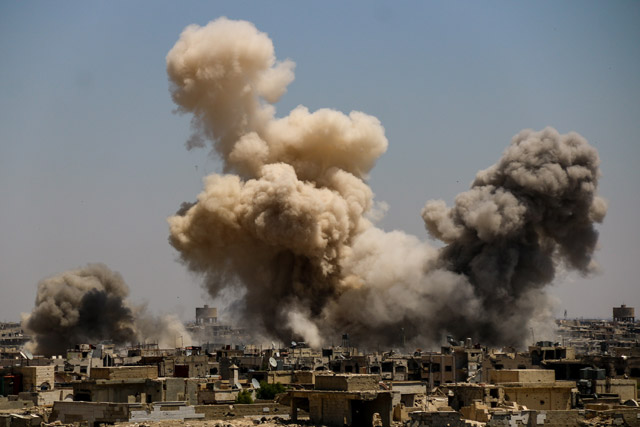 A huge explosion sends clouds into the air after government forces reportedly carried out air and ground strikes over the rebel-held Ein Tarma district in the Eastern Ghouta region of Damascus, Syria, on Monday (Anadolu Agency photo)