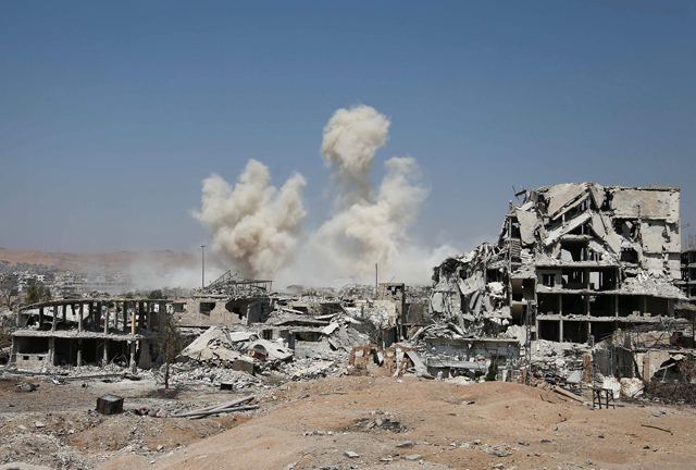 Smoke rises from buildings following a strike on a rebel-held area of the Jobar district, east of the Syrian capital, on Thursday (AFP photo)