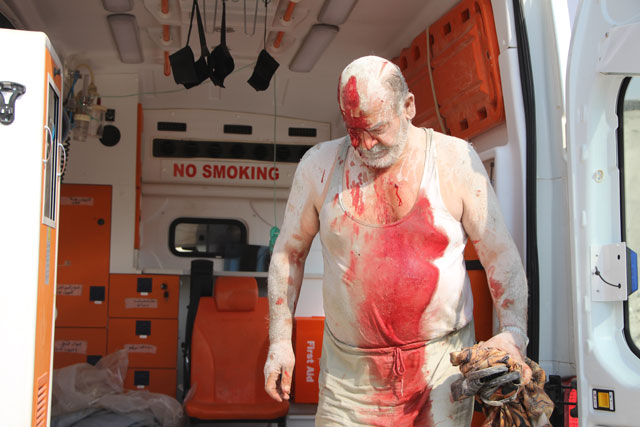A wounded Syrian man is seen inside an ambulance as he is being taken to Sahra Hospital after air strikes hit Khan Sheikhoun town of Idlib, Syria, on Thursday (Anadolu Agency photo)